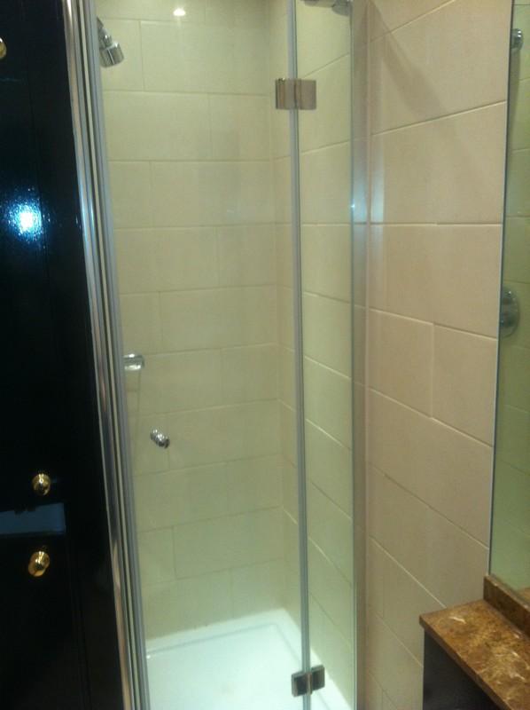 Frameless glass shower enclosure with chrome fittings in Leighton Buzzard